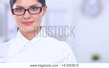 Attractive businesswoman with her arms crossed stnding