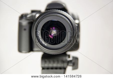 Looking in the eye of a digital camera in photo studio. Lens close up
