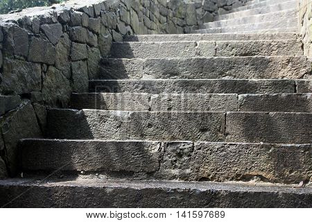 beautiful old stone stairs natural dark stone diabase with stone steps in summer park outside in Crimea