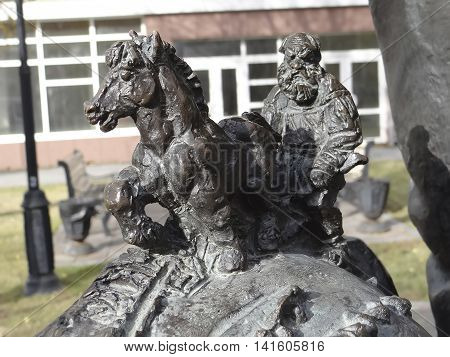 TOBOLSK, RUSSIA - OCTOBER 15, 2013 : Photo of Detail of the monument to Yershov. Lev Tolstoy plowing on back Fish - Whale.