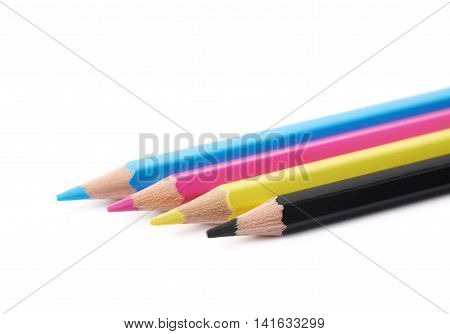 Four cmyk colored drawing pencils composition isolated over the white background, close-up crop