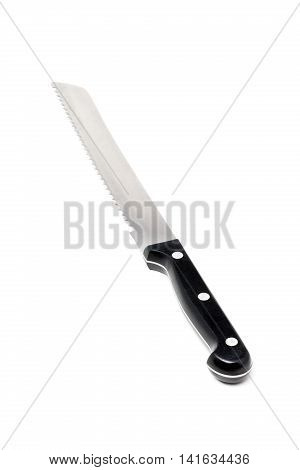 Serrated bread knife with black handle over white background