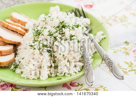 White Rice With Greens And Sliced Pieces Of Meat Grilled On A Green Plate