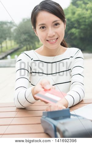 Woman using credit crad to pay