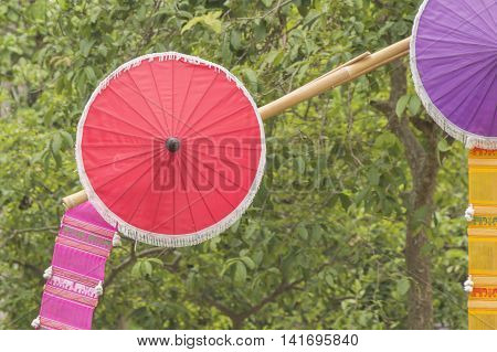 Thailand red umbrellas front of nuture background