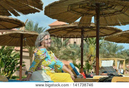 Happy Mature woman  near pool on vacation