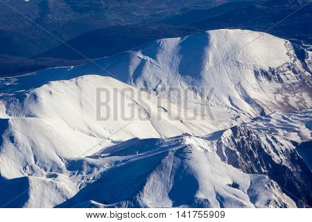 Aerial view of a snowy mountain. Winter Background