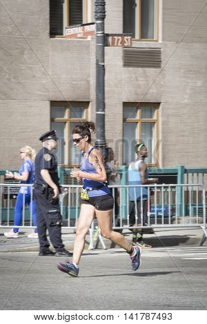 NEW YORK CITY -  JULY 24 2016: Athletes running in the NYC Triathlon Race on West 72nd St cross over Central Park West. The run is 10k and the race is the only International Distance triathlon in the city.
