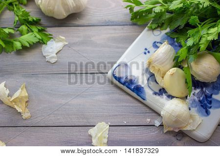 Garlic and parsley on ceramics cutting board