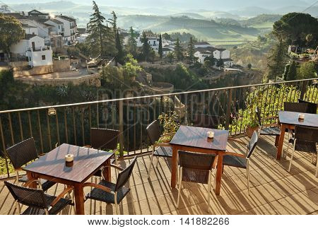 Cafe view in Ronda, Andalusia, Spain. Old town cityscape on the Tajo Gorge