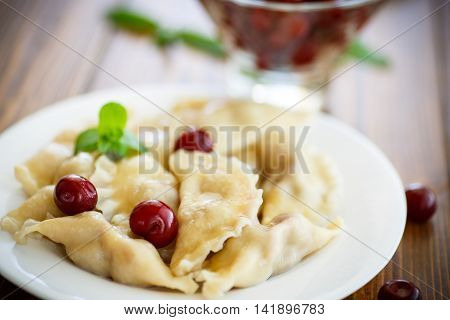 boiled dumplings stuffed with cherries on a plate