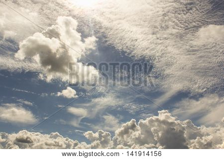 Cirrus clouds in the blue sky.
Cumulus and cirrus clouds illuminated by the sun.