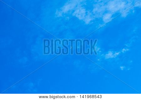 The blue sky with the Moon in the middle.