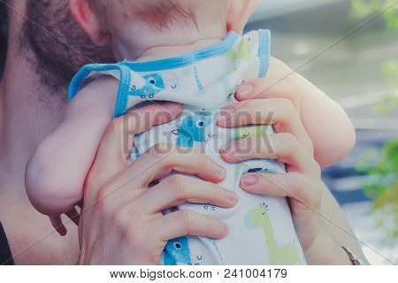 Close-up To Hands  Of Father Embracing And Kissing His Sweet Ado