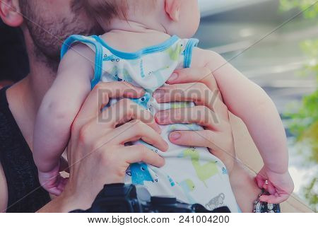 Close-up To Hands  Of Father Embracing And Kissing His Sweet Ado
