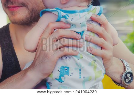 Close-up To Hands  Of Father Embracing And Kissing His Sweet Ado