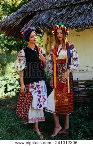 Two Beautiful Ukrainian Girl  Blond And Brunette In National Embroidered Clothes On A Background Of 