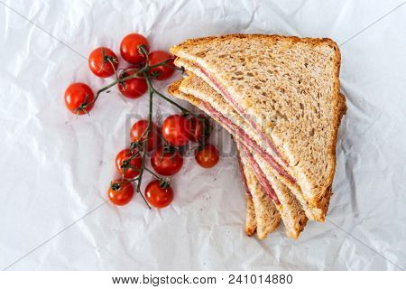 Wholemeal bread sandwich topped with Lyon rosette and butter