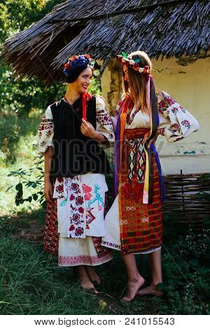 Two Beautiful Ukrainian Girl  Blond And Brunette In National Embroidered Clothes On A Background Of 