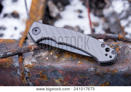 A Small Pocket Knife. The Knife On The Rusty Iron.