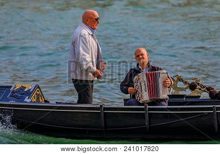 Venice, Italy - September 23, 2017: Man Serenades Gondola Riders To An Accompaniement Of An Accordeo