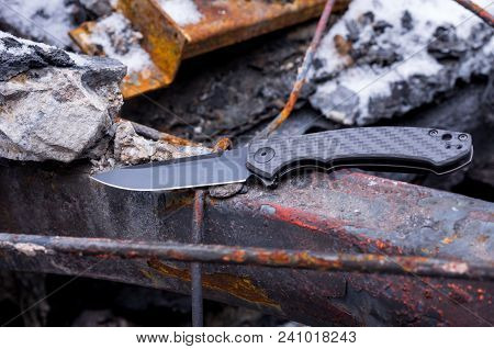 Knife With A Black Blade And Handle.