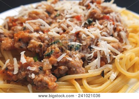 Appetizing Spaghetti In A Plate With Bolognese Sauce On A Dark Background Close Up