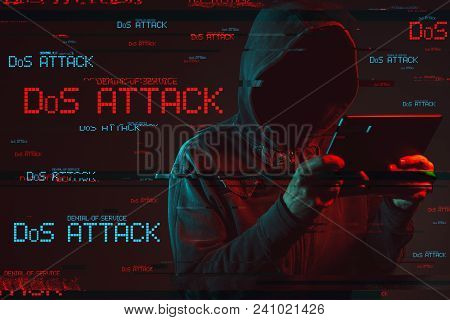 Denial Of Service Or Ddos Attack Concept With Faceless Hooded Male Person Using Tablet Computer, Low
