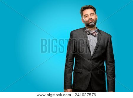 Middle age man, with beard and bow tie with sleepy expression, being overworked and tired