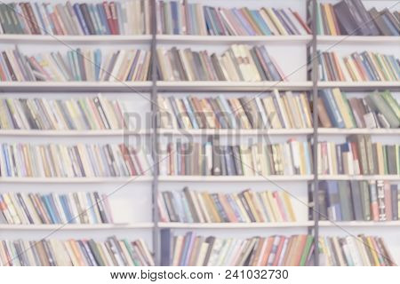 Abstract Blurred Background Of Bookshelves With Books In Public Library, Book Store, At Home, Modern