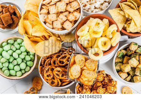 Variation Different Unhealthy Snacks Crackers, Sweet Salted Popcorn, Tortillas, Nuts, Straws, Bretse
