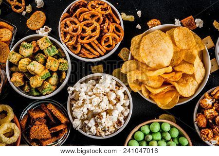 Variation Different Unhealthy Snacks Crackers, Sweet Salted Popcorn, Tortillas, Nuts, Straws, Bretse