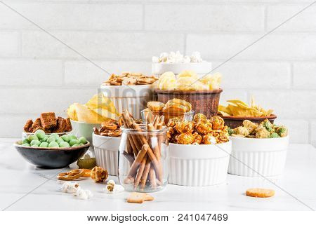 Variation Different Unhealthy Snacks Crackers, Sweet Salted Popcorn, Tortillas, Nuts, Straws, Bretse