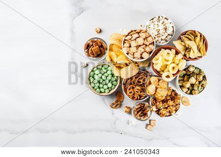 Variation Different Unhealthy Snacks Crackers, Sweet Salted Popcorn, Tortillas, Nuts, Straws, Bretse