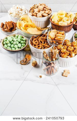 Variation Different Unhealthy Snacks Crackers, Sweet Salted Popcorn, Tortillas, Nuts, Straws, Bretse