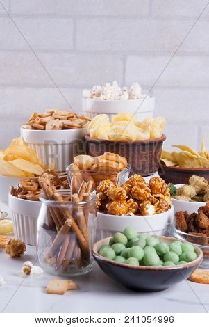 Variation Different Unhealthy Snacks Crackers, Sweet Salted Popcorn, Tortillas, Nuts, Straws, Bretse