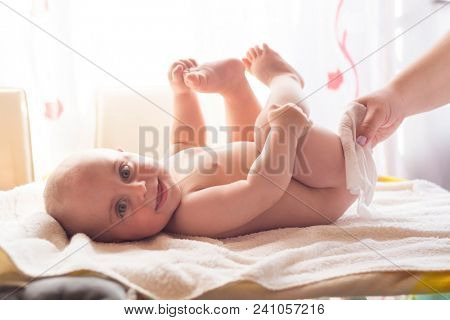 Hygiene - young momy wiping the baby skin with wet wipes. Cleaning wipe, pure, clean