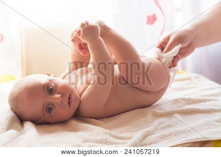 Hygiene - young momy wiping the baby skin with wet wipes. Cleaning wipe, pure, clean