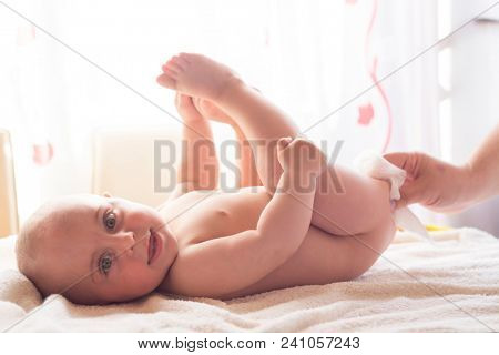 Hygiene - young momy wiping the baby skin with wet wipes. Cleaning wipe, pure, clean