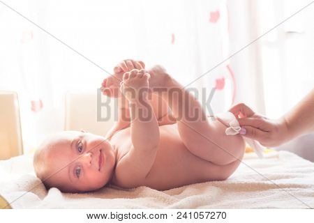 Hygiene - young momy wiping the baby skin with wet wipes. Cleaning wipe, pure, clean