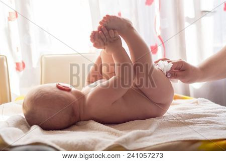 Hygiene - young momy wiping the baby skin with wet wipes. Cleaning wipe, pure, clean