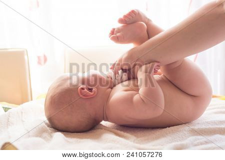 Hygiene - young momy wiping the baby skin with wet wipes. Cleaning wipe, pure, clean