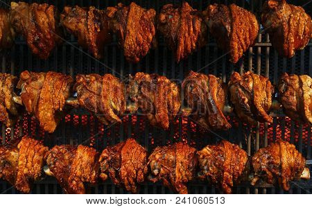 Several Traditional Bavarian German Roasted Pork Knuckles Slowly Cooked At Rotating Broiling Rack Gr