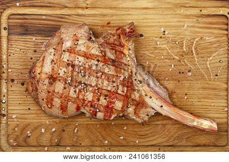 Close Up One Grilled Roasted Tomahawk Ribeye Beef Steak With Rib Bone On Wooden Cutting Board, Eleva