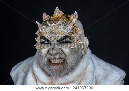 Demon On Black Background, Close Up. Man With Thorns Or Warts In Fur Coat. Alien, Demon, Sorcerer Ma