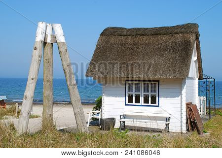 Typical Small Thatched Roof House In Scharbeutz, Germany