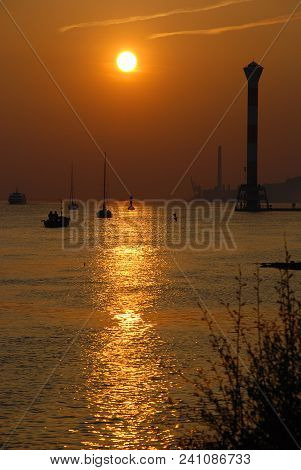 Sunset At Elbe River, Hamburg, Germany, In The Background The Lighthouse Of Blankenese