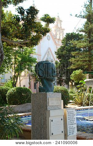 Sculpture Of Jose Marti, Alameda Park, Cadiz, Spain. In The Backgound Iglesia Ntra Sra Del Carmen Y 