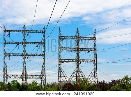 Two Large Rectangular High-voltage Electrical Transmission Towers With Power Lines And Insulators Ab