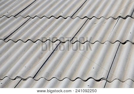 A Fragment Of A Gray Slate Roof Of An Old Sample Made Of Asbestos Material